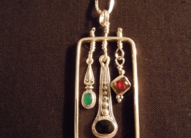 Earrings framed into a silver pendant
